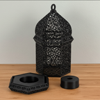 Black decorative lantern with two additional black components on a wooden surface.
