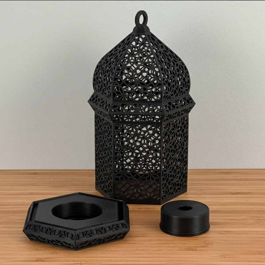 Black decorative lantern with two additional black components on a wooden surface.